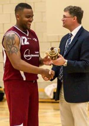 ADA Bexhill Giants captain Craig Douglin receives the Sussex Basketball Cup. Picture courtesy webphotouk.com