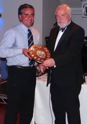 Kit Claughton receives the president's shield from Peter Southee at Hastings & Bexhill Rugby Club's awards night