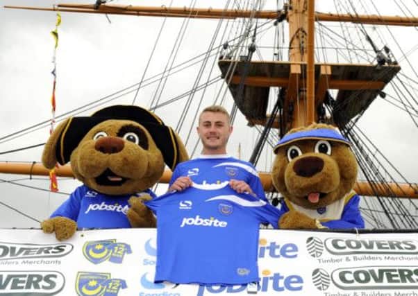 Dan Butler, centre, shows off the new kit with Pompey mascots Nelson and Mary Rose. Picture: Allan Hutchings (131330-135)