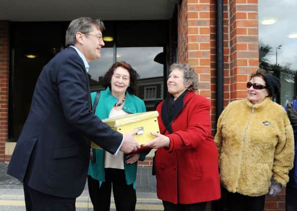 The Littlehampton Civic Society's secretary, Angela Tester, hands over the petition box to councillor Paul Dendle, in February