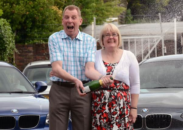 Lottery winners Paul and Pat West with their new BMWs L22553H13