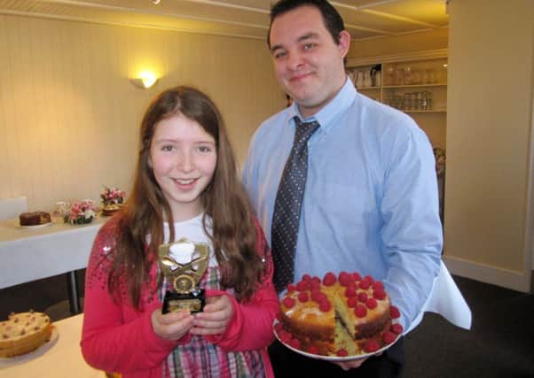 2012 Junior winner of cake bake Hannah Naismith and Seth Gulliver Catering Manager at Bodiam Castle