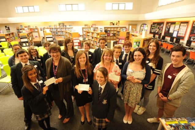 Felpham Community College students presenting their cheques to from the left Sally Huggins, Cancer Research UK, Julie Longman, St Wilfrid's Hospice and Michelle McKinley-Bell  of the Aldingbourne Trust


Picture by Louise Adams C130704-1 Bog Cheque