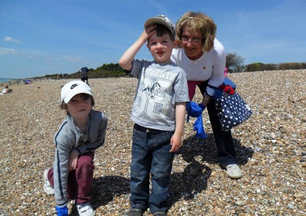 Linda Denton and her two grandsons during the beach clean event in East Preston, on Sunday.