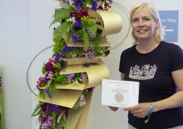 Louise Mosey with her Silver Gilt and floral interpretation 'Press Release'. Picture submitted