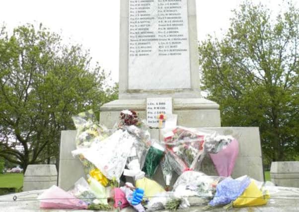 Floral tributes in memory of drummer Lee Rigby, left on Littlehamptons war memorial