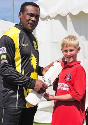 West Indies great Gordon Greenidge signs a cricket bat for nine-year-old Charlie Everitt. Picture by Tony Coombes Photography (eh22900g)