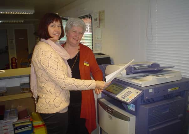 Centre manager Julie Roby with volunteer Margaret Harding and the new photocopier
