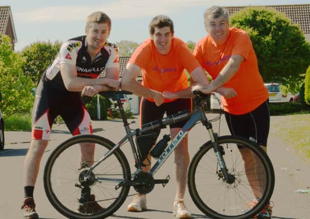 Herald & Gazette reporter Tom Cotterill, centre, with dad Steve and friend, Sam Penny, left. They will all be taking on a triathlon for three charities  L23701H13