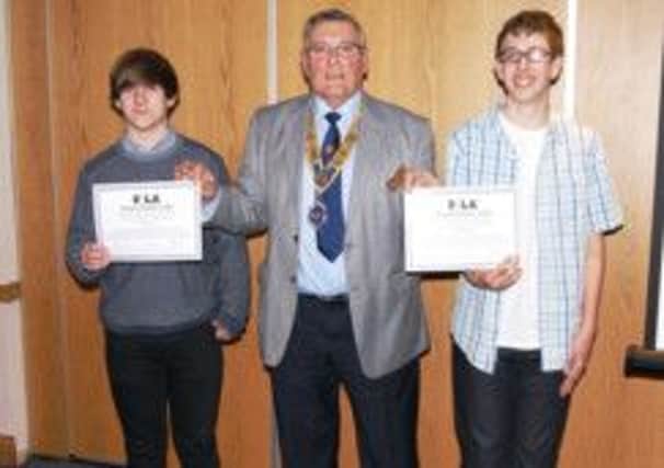 Littlehampton Rotary Club president Geoff Watts presents Rotary Youth Leadership Award certificates to Tim Spencer (left) and Callum Block