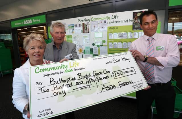 Asda manager Martyn Compton presents a cheque for £250