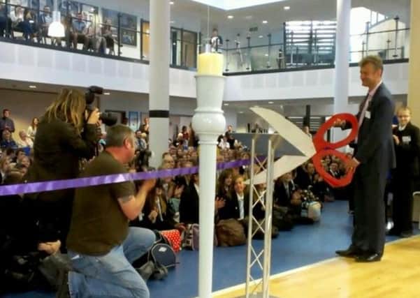 Hugh Dennis cuts the ribbon at The Littlehampton Academy.