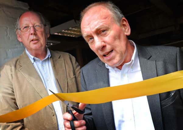 JPCT 070613 S13240040x  Warnham Mill Veterinary Surgery opens. Christopher Timothy, of All Creatures Great and Small, cuts the ribbon. Julian Peters, Owner of Arthur Lodge Veterinary Group, looks on -photo by Steve Cobb