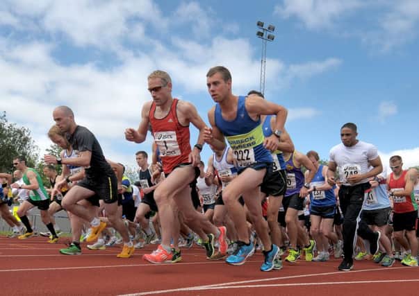 Eventual winner James Baker is in the red vest as the D-Day 10k Race starts at the Mountbatten Centre Picture by Mick Young