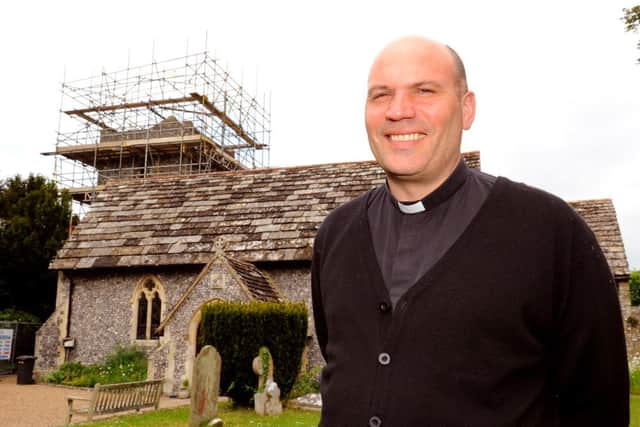 JPCT 100613 Rev John Challis outside St Peter's Church, Upper Beeding . The congregation has been fundraising £250,000 to fix the roof and other parts of the building. The work has finally started. Photo by Derek Martin