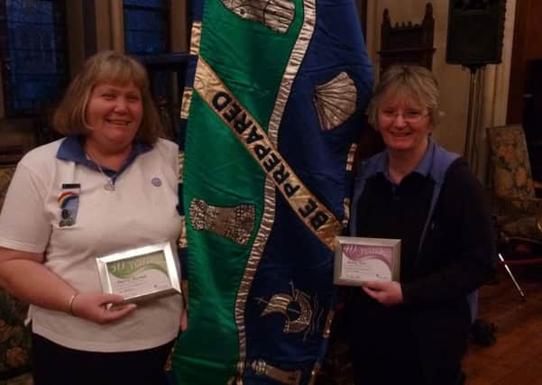 Sherrie Durrant and Sandy Tout with their long-service awards