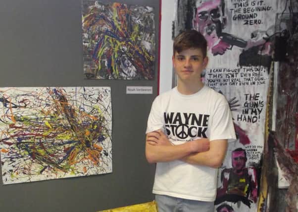 Noah Verbeeten alongside his fantastic GCSE art work