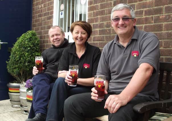 Samantha Walker, with brother-in-law Neil Walker (left) and former managing director Jeremy Owens, toast the future of Arundel Brewery