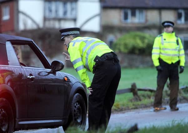 Police officers stop to interview motorists at the Fernhurst murder scene .


Photo by Louise Adams C130132-1