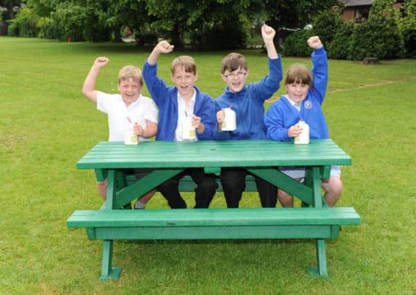 Pupils at Shelley Primary School and their new recycled picnic table