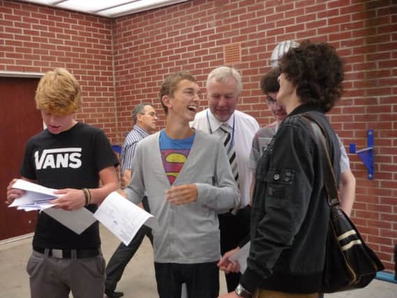 Pupils getting their GCSE results at Chatsmore, with head teacher Mike Madden (white shirt) looking on.