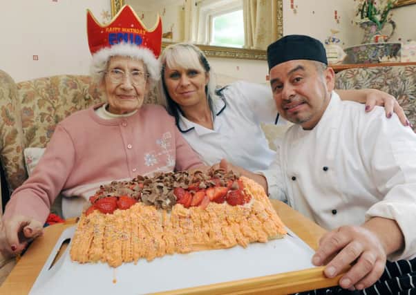 W25805H13 

103 year old Enid Wells of Maderira Avenue Worthing with care home manager Anna Jarszak and Chef Francisco Canals