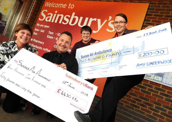 Cheque presentation by Sainsburys to Sussex Air Ambulance. l-r Cheryl Johnson (Sussex Air Ambulance), with Sainsburys employees Rob Lyne, Charlotte Wiles and Amy underwood
