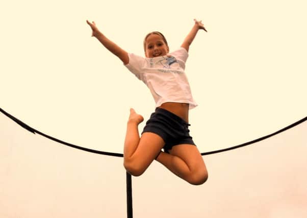 Grace Hartley (8)  is trying to break her own record of somersaults on a bungee trampoline to raise money for charity.