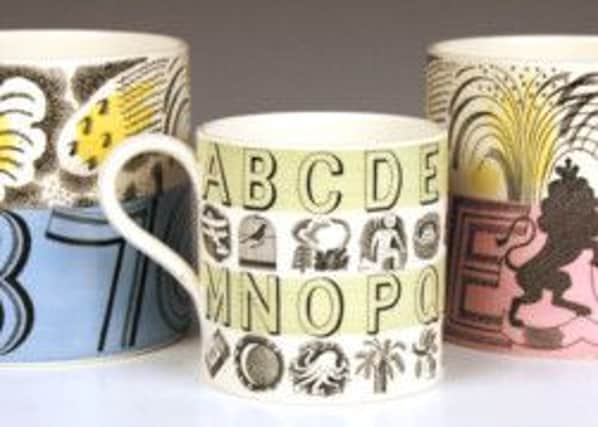 A collection of Wedgwood mugs, designed by Eric Ravilious. From left to right: a George VI coronation cup, circa 1937, an alphabet mug, circa 1937, and an Elizabeth II coronation cup, circa 1953.