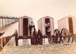A line of Mr Jenkins bathing machines by the pier.