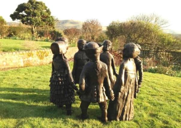 The sculpture is called 'Children of the Fair' by Sylvia Thornhill.