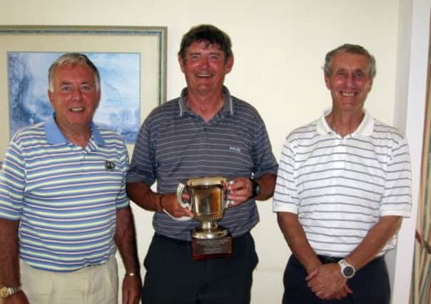 Mike Snuggs, centre, with his Chichester vets' championship trophy