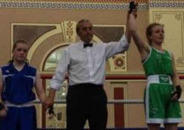 Belinda Skinner, of West Hill Boxing Club, raises her arm in victory at the Haringey Box Cup