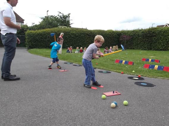 Children in Busy Bees at Browns Lane Pre-School in Storrington learning golf with  James Crawford PGA professional