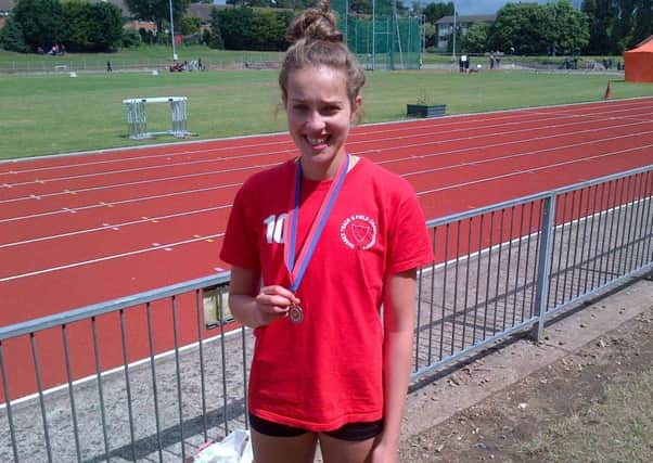 Izzie Brown with her medal at Watford