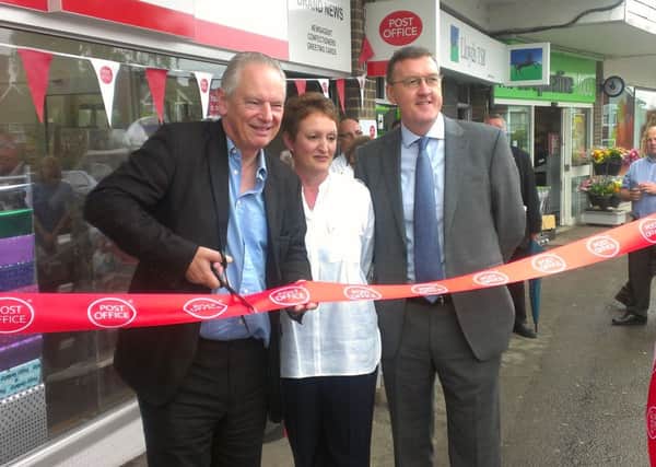 Francis Maude cuts the ribbon at the official opening of a new post office in Brand News, Fitzalan Road, Roffey.