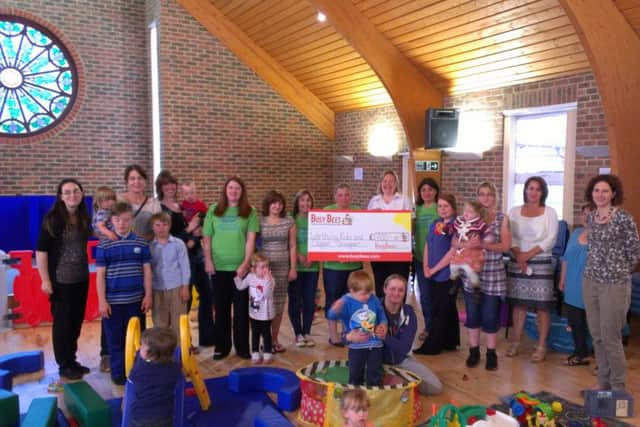 WKDS members and staff receive a cheque for £700 from Busy Bees nursery