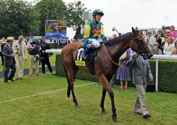 Boom And Bust, ridden by Hayley Turner, in the winner's enclosure after the 2011 Betfair Mile - could the same horse win it again this year? Picture by Malcolm Wells