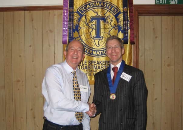 Bexhill solicitor Giles Robinson  becomes president of Battle Speakers' Club. He is seen here (wearing chain) with outgoing president, Graham Gardner