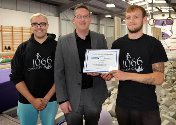 Presentation to Liam Noakes from Spectrum Independent Financial Advice at 1066 Gym Academy. Matthew Hart, head coach, Jeremy Over, Spectrum, and Liam Noakes.