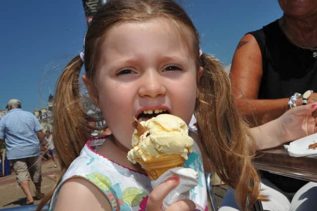 Local girl 4 year old Scarlett Roberts enjoys an ice cream on the seafront at Eastbourne July 8th 2013 E28096P