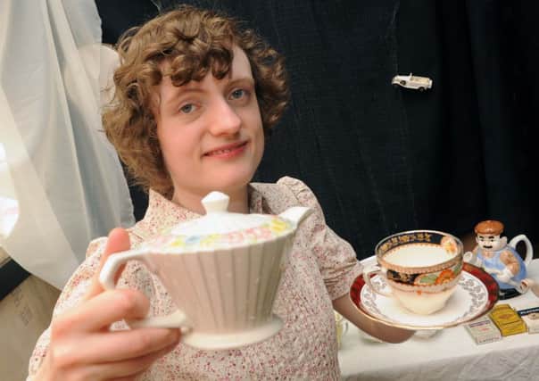 Christine Cooper pouring a cup of tea in her vintage tearoom