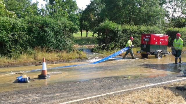 Engineers install a pump to drain the flooded A259
