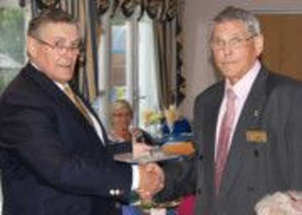 Littlehampton Rotary chairman Geoff Watts (left) presents member John Mitchell with his Paul Harris Fellowship award