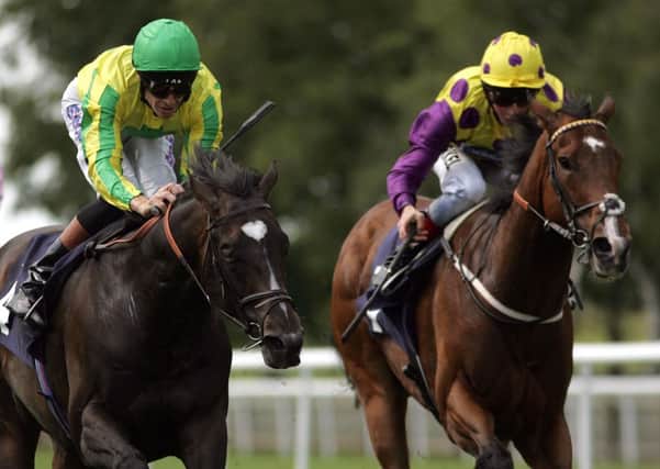 Richard Hughes riding Libranno (L) leads home the pack to win the Criterion Stakes