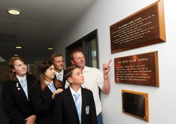 Pupils Josh Hickman, James Biffi, Megan Fullard and Damiela Mendes with Tim Jackson who rescued the two plaques L28922H13