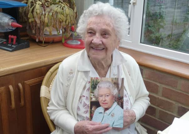 Elsie Bracher and her 100th birthday card from the Queen