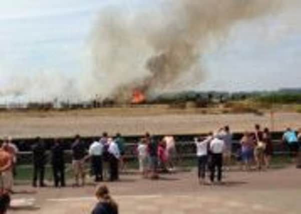 German tourist Wolfgang Marin took this pictur of the fire raging in Littlehampton, with onlookers watching the drama unfold