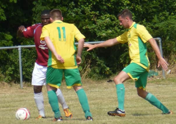 Westfield pair Lewis Parsons and Liam Miles keep a close eye on Hastings United striker Bailo Camara. Picture by Simon Newstead