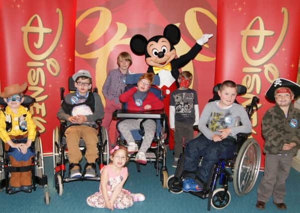 Children from Chestnut Tree House children's hospice enjoy a visit from Mickey Mouse